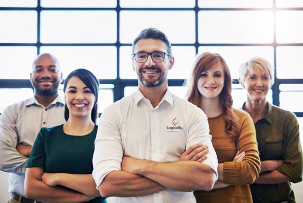 Portrait of a team of logically colleagues standing together with their arms crossed in a modern office