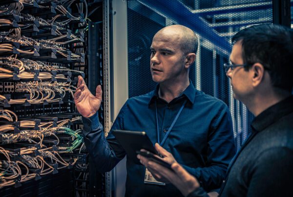 IT technician explaining server configuration to a manager
