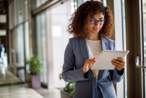 Young businesswoman using digital tablet indoors
