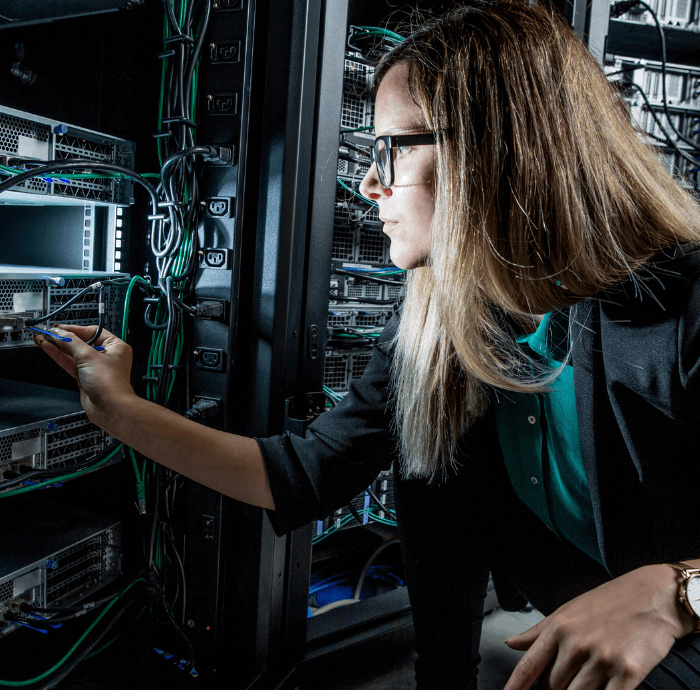 Woman analyzing and making fixes to a computer's motherboard