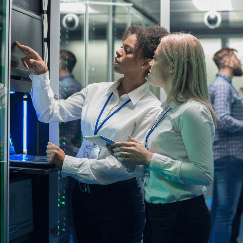 Two women analyzing the information that appears in a computer screen