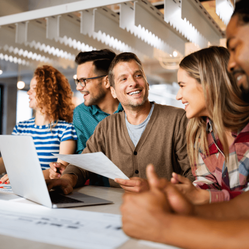five coworkers discussing an assignment