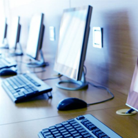 A row of computers on a desk